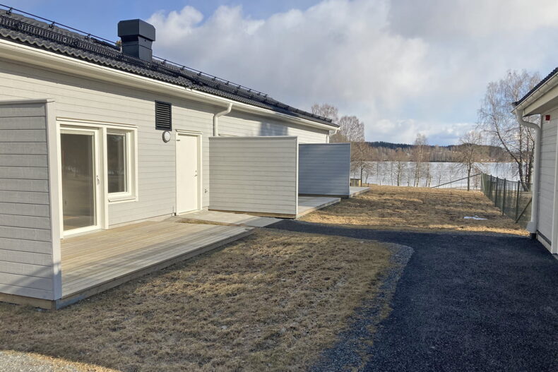 Gräsytan mellan boendets uteplatser, med utsikt mot sjön Ljustern